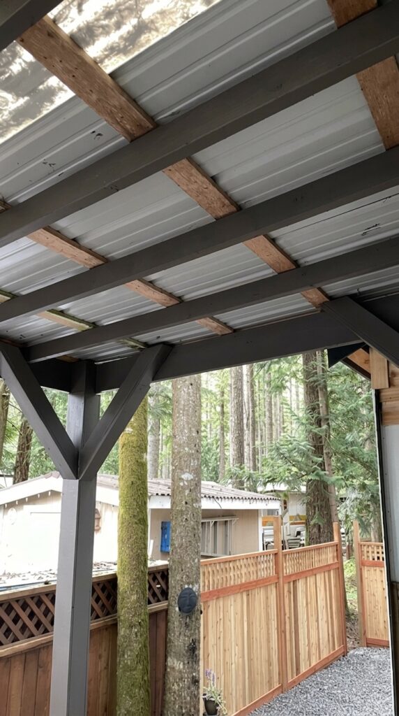 Patio cover ceiling after painting with exposed wood beams and roof panels