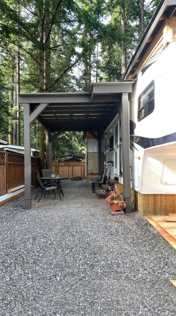 Finished ranch patio makeover with Sherwin-Williams Black Fox painted patio cover, white fifth wheel trailer, gravel, and outdoor seating