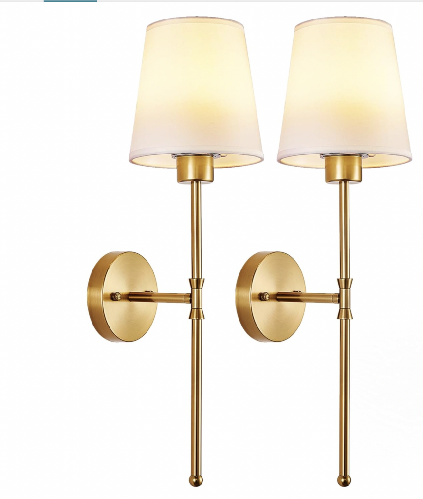 a pair of antique gold wall sconces with neutral shade